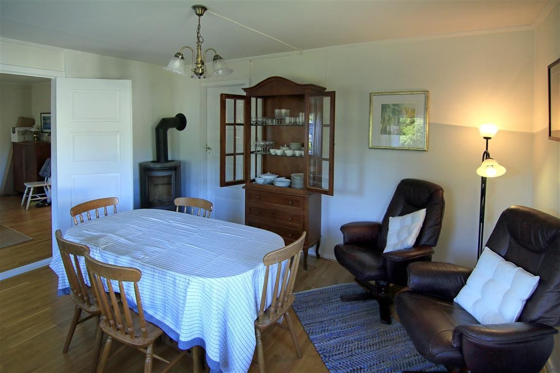 Fra spisetuen med lesekroken. Vitrineskapet er velassortert mht hva man ønskerfor å servere drikke til maten eller kaffen Galleribilde