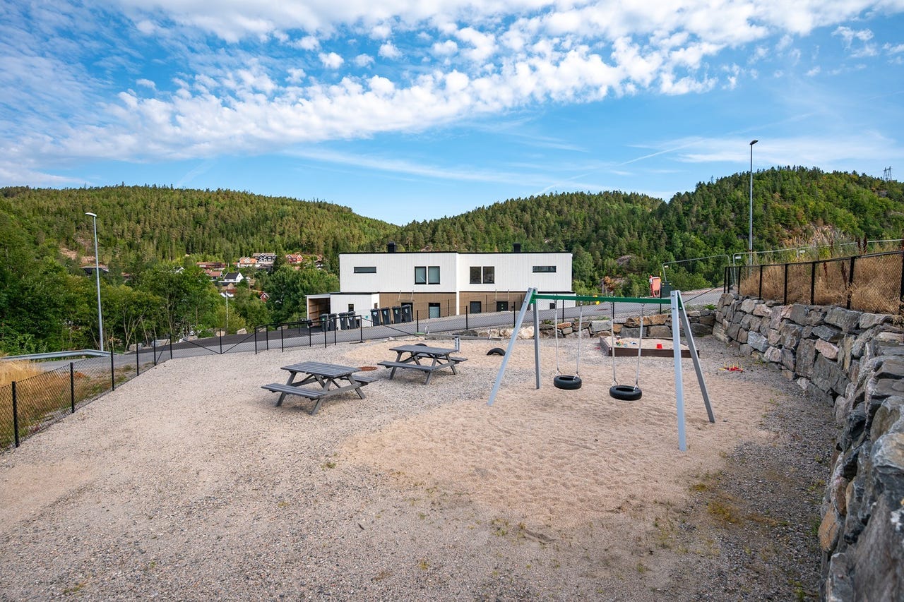 Familievennlig med benker, huske, runse og sandkasse