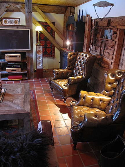 Møblert med bl.a. chesterfield og unike bord, skap og div. i resirkulert materiale. Galleribilde