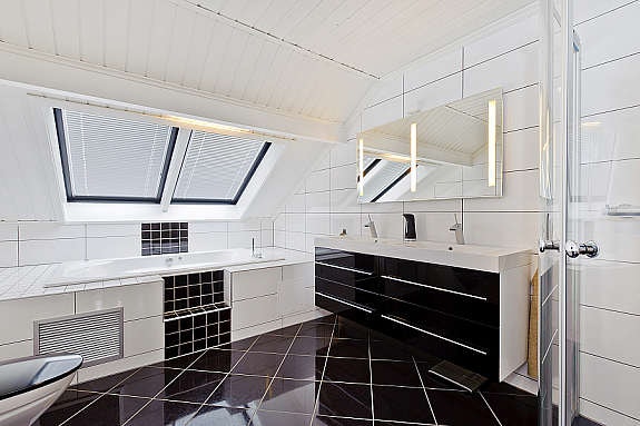 Badet ligger i 2 etasje og innholder toalett, innebygd boblebad, dusjhjørne, møbler og servant. Galleribilde