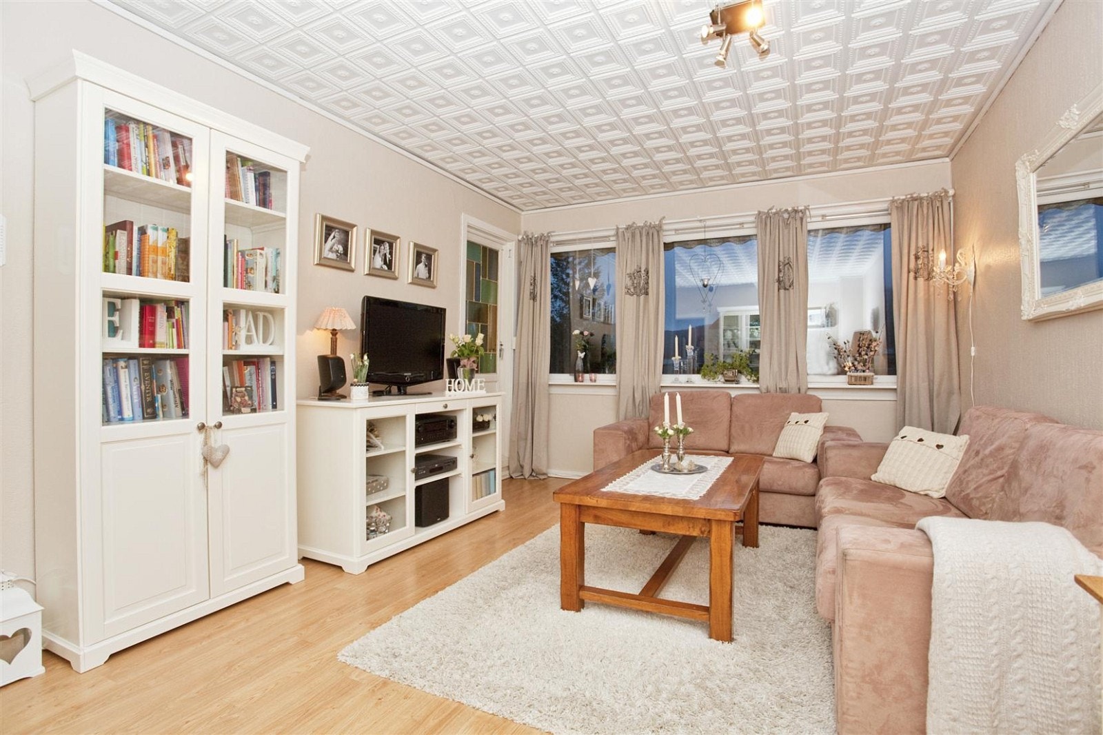 Tidsriktig og lys stue med moderne fargetoner og eikelaminat på gulvet. Galleribilde