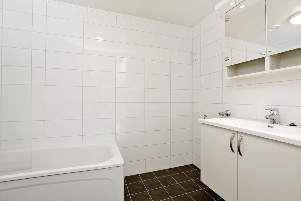 Bad i kjeller med badekar og badekarvegg. Opplegg for vaskesøyle. Galleribilde