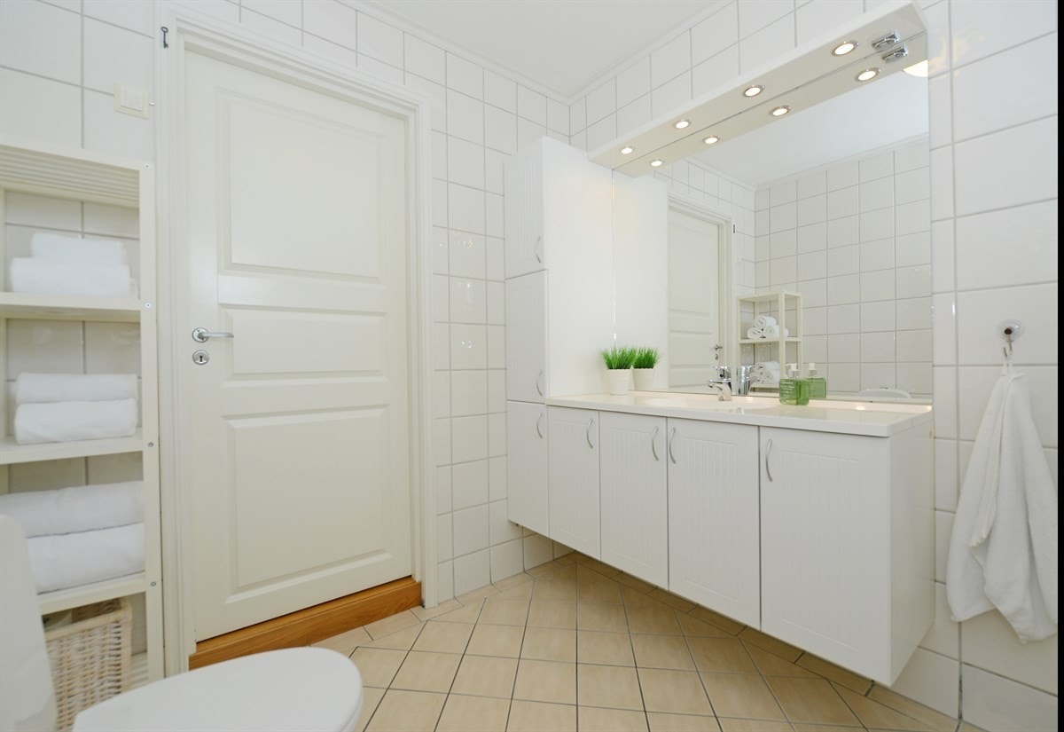 På badet er det lyse fliser på vegger og gulv, varmekabler i gulv og pen innredning fra Foss Bad. Galleribilde