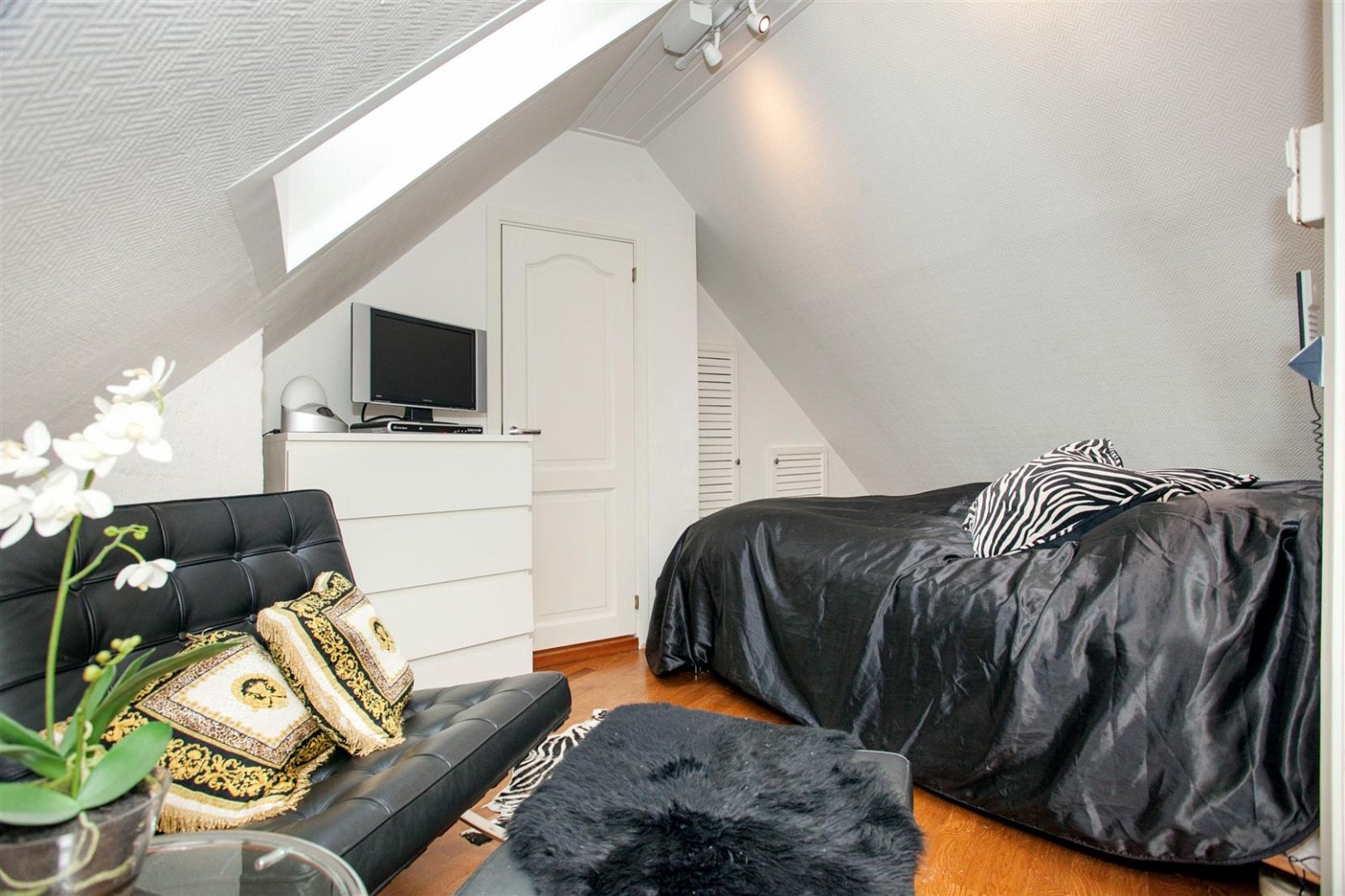 Soverom med skråtak og inngang til eget bad Galleribilde