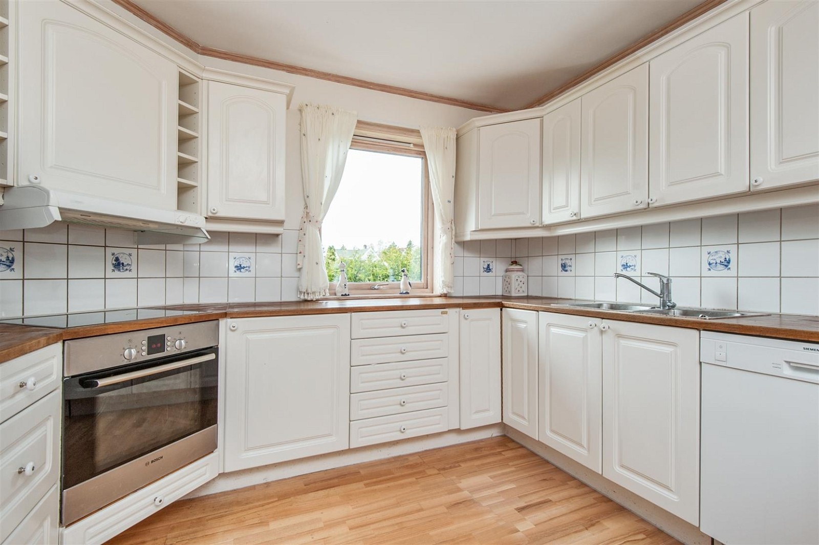 Innholdsrikt kjøkken med rikelig skap- og benkplass. Galleribilde