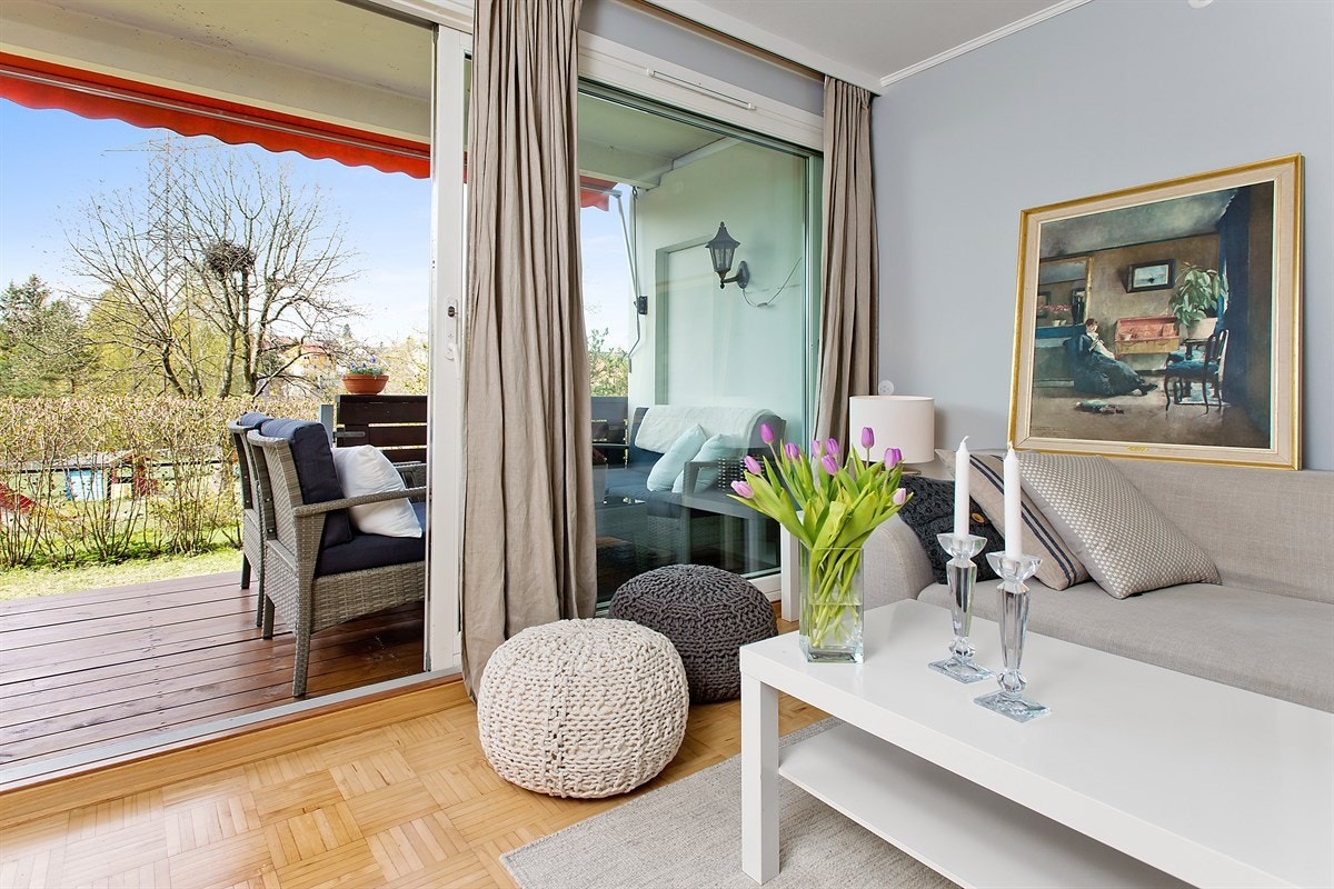 Stuen er lys med store vindusflater og utgang til terrassen og hagen. Galleribilde