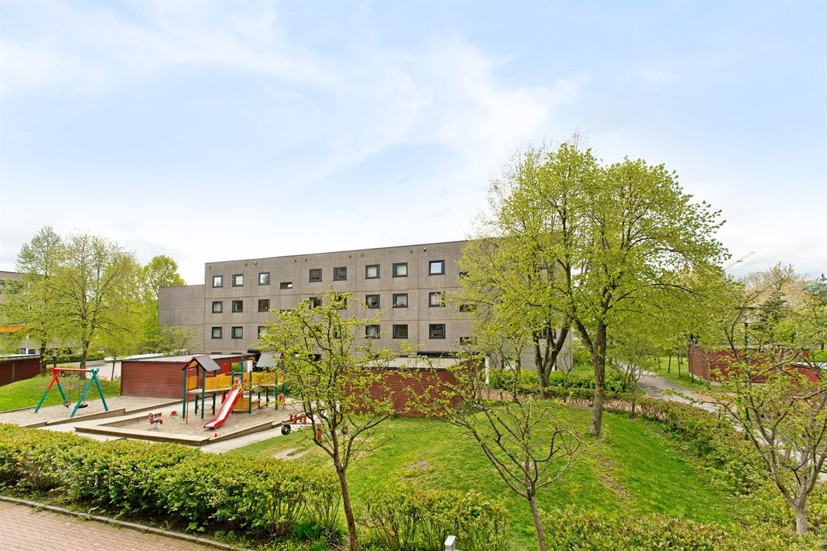 Pent utsyn over grønt og velstelt indre gårdsrom Galleribilde