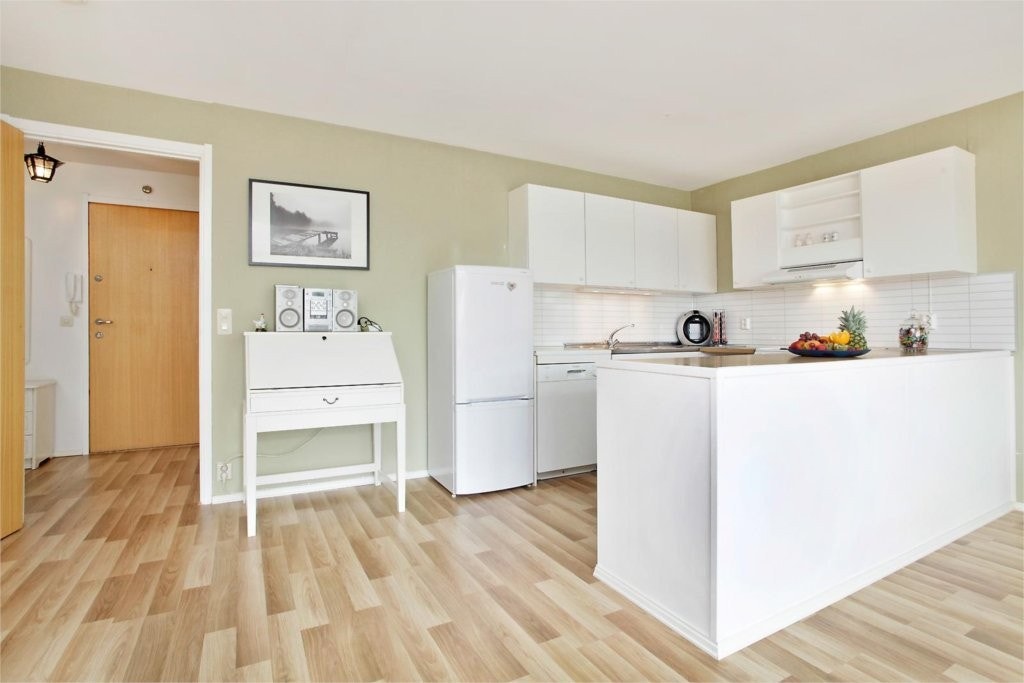 Praktisk kjøkken med nye plater over kjøkkenbenk. Galleribilde