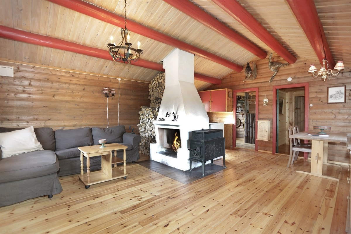 Stua har mønet himling med malte tømmeråser, noe som gir en fin hyttestemning. Galleribilde