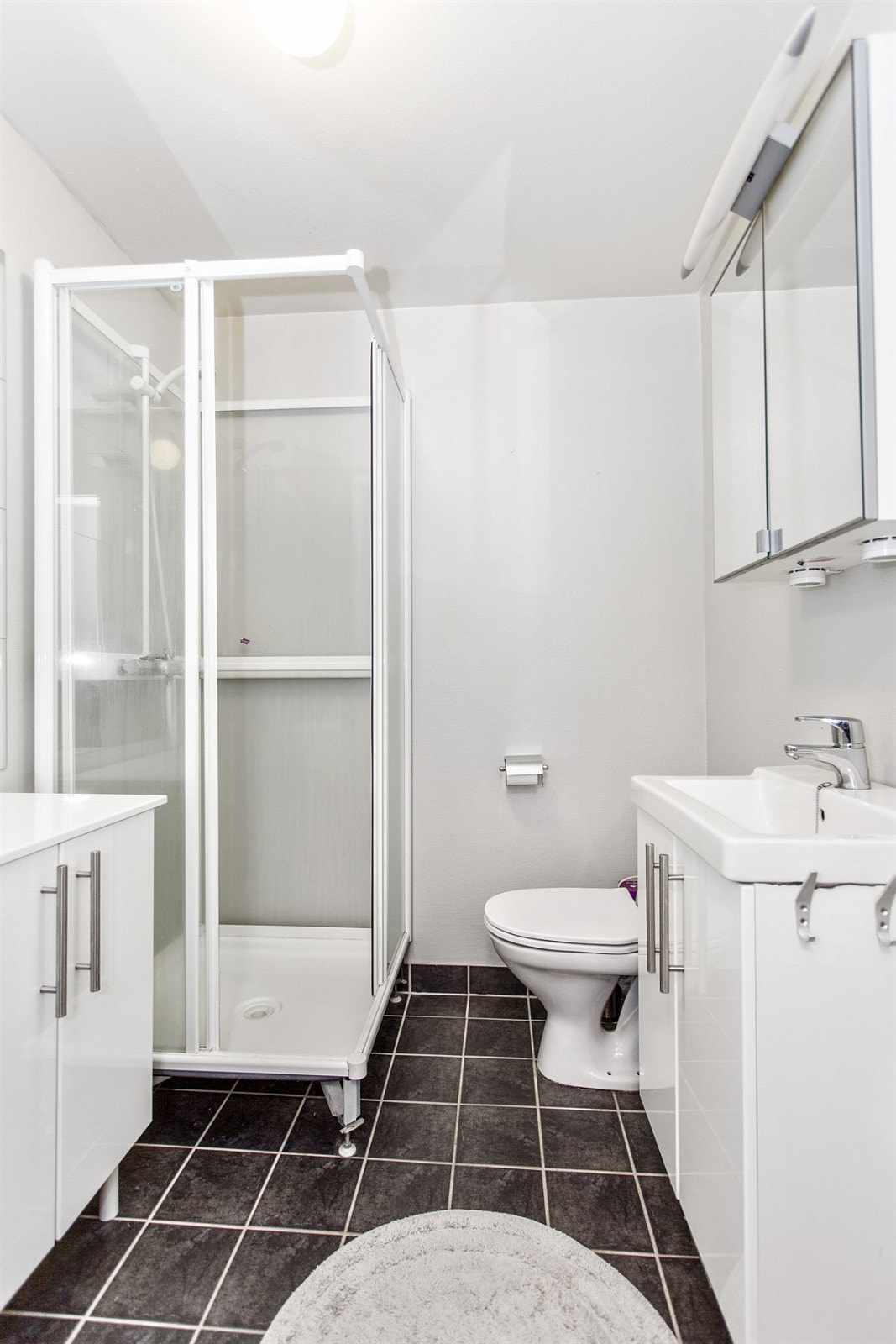 Lyst bad med flislagt gulv. Galleribilde