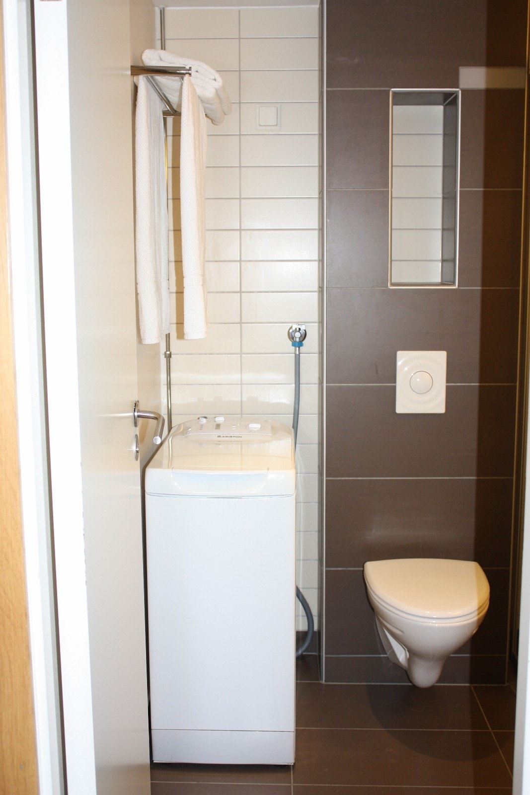 Vegghengt klosett og toppmatet vaskemaskin Galleribilde