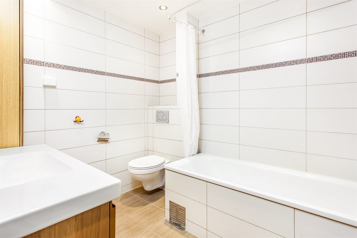 Lekkert, flislagt bad med badekar Galleribilde