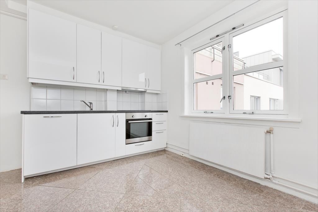 Lekker, nytt kjøkken med skapfronter i hvit høyglans og integrerte hvitevarer. Galleribilde