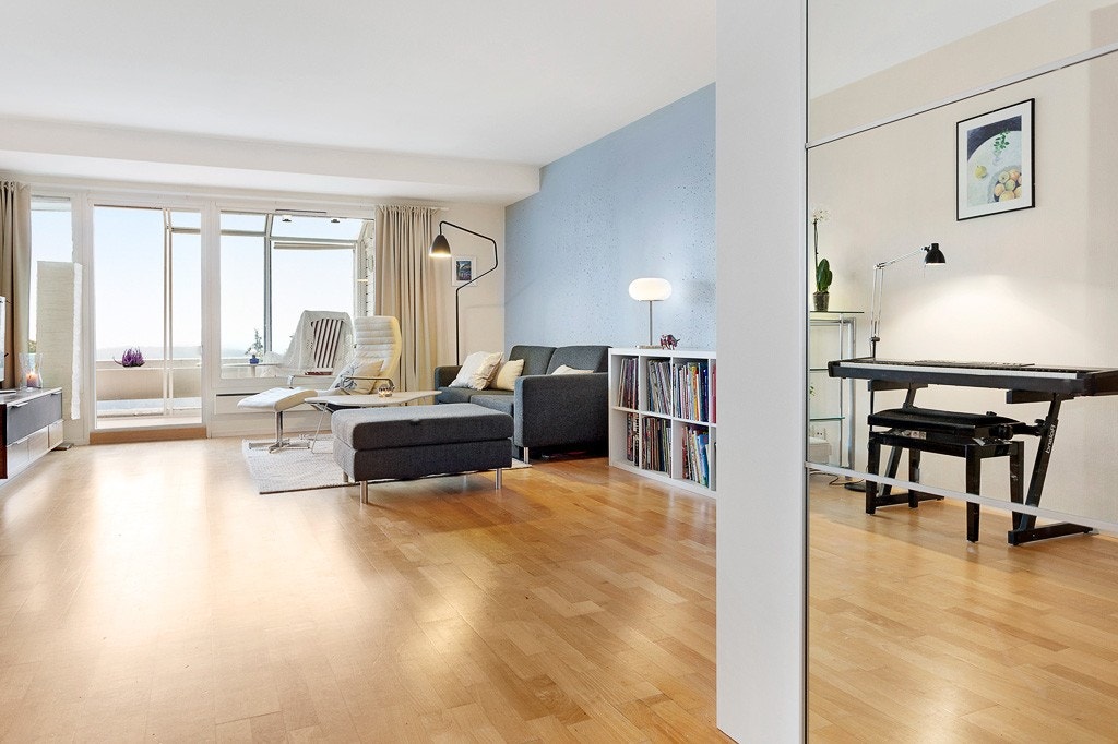 Leiligheten har en romslig stue med store vindusflater, som gir godt med naturlig lys. Galleribilde