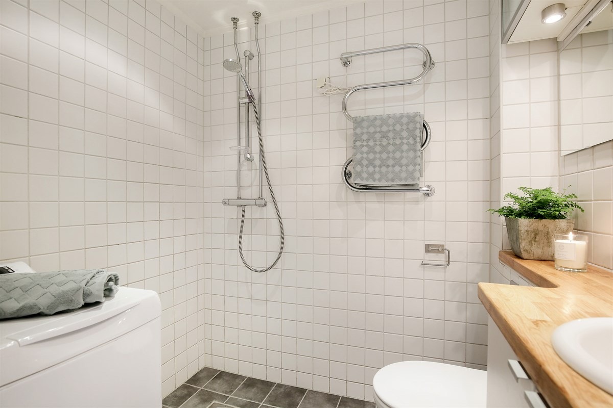 Her har du dusj, elektrisk håndkletørker, klosett, servant og baderomsinnredning, samt opplegg for vaskemaskin. Galleribilde