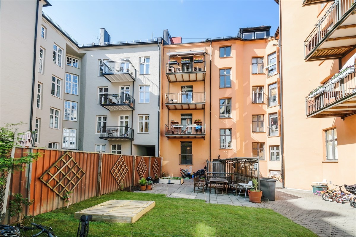 Bakgården er pent opparbeidet med sittegrupper og plen samt beplantning. Galleribilde