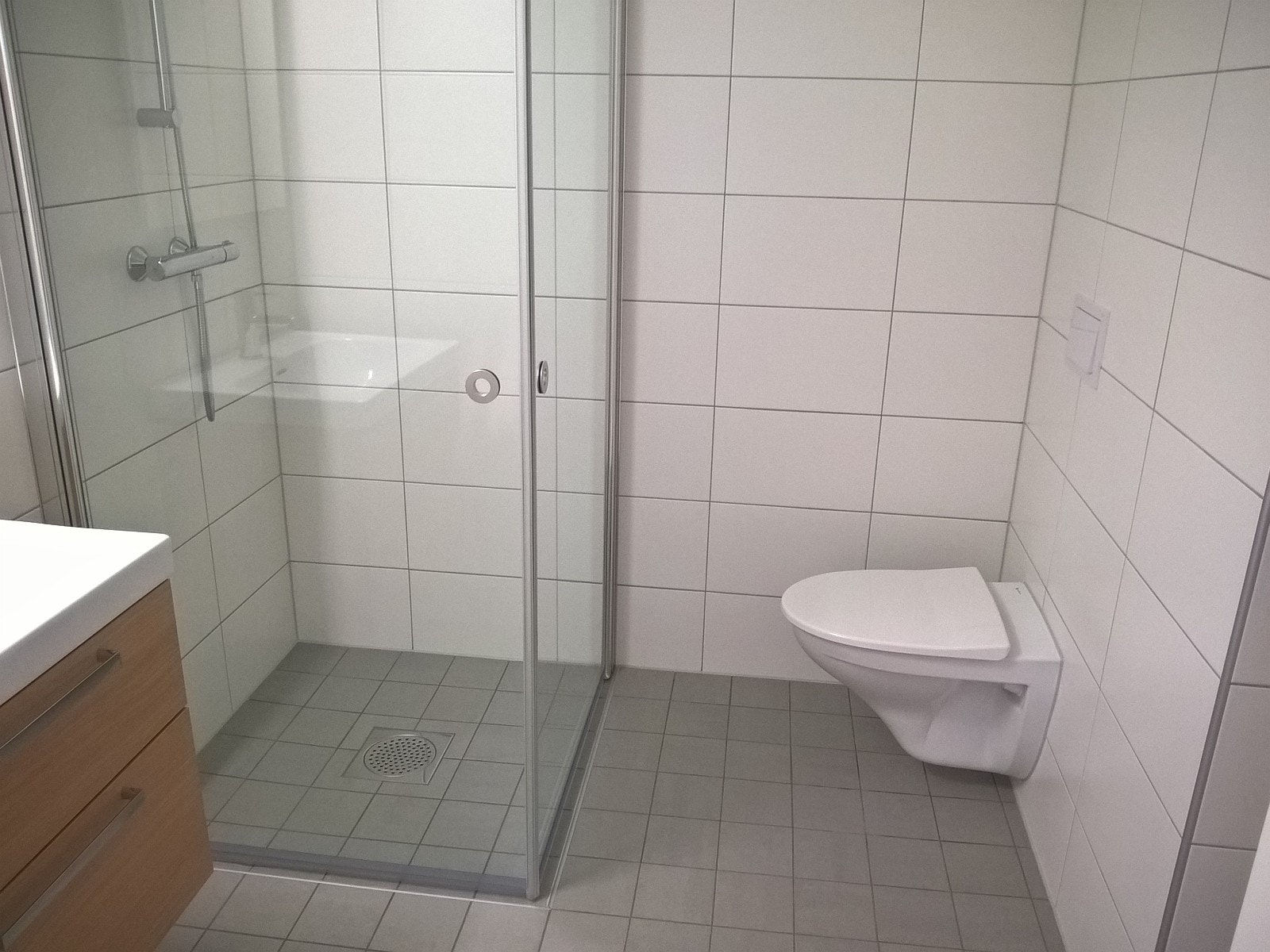 Flislagt bad med varmekabler og vegghengt toalett Galleribilde