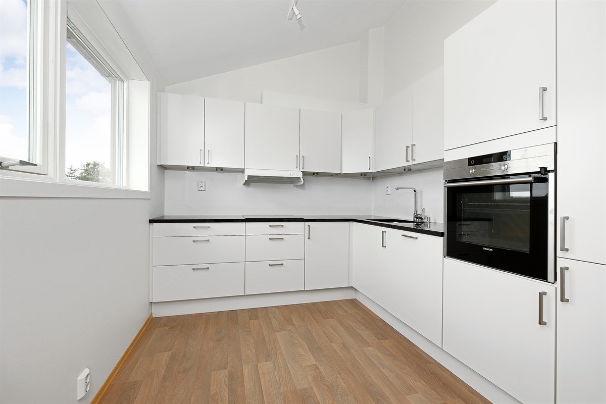 Flott kjøkken fra kvalitetsleverandøren HTH med slette fronter. Benkeplate av granitt (Silver Galaxy), stål vaskekum og ventilator med utluftning. Galleribilde