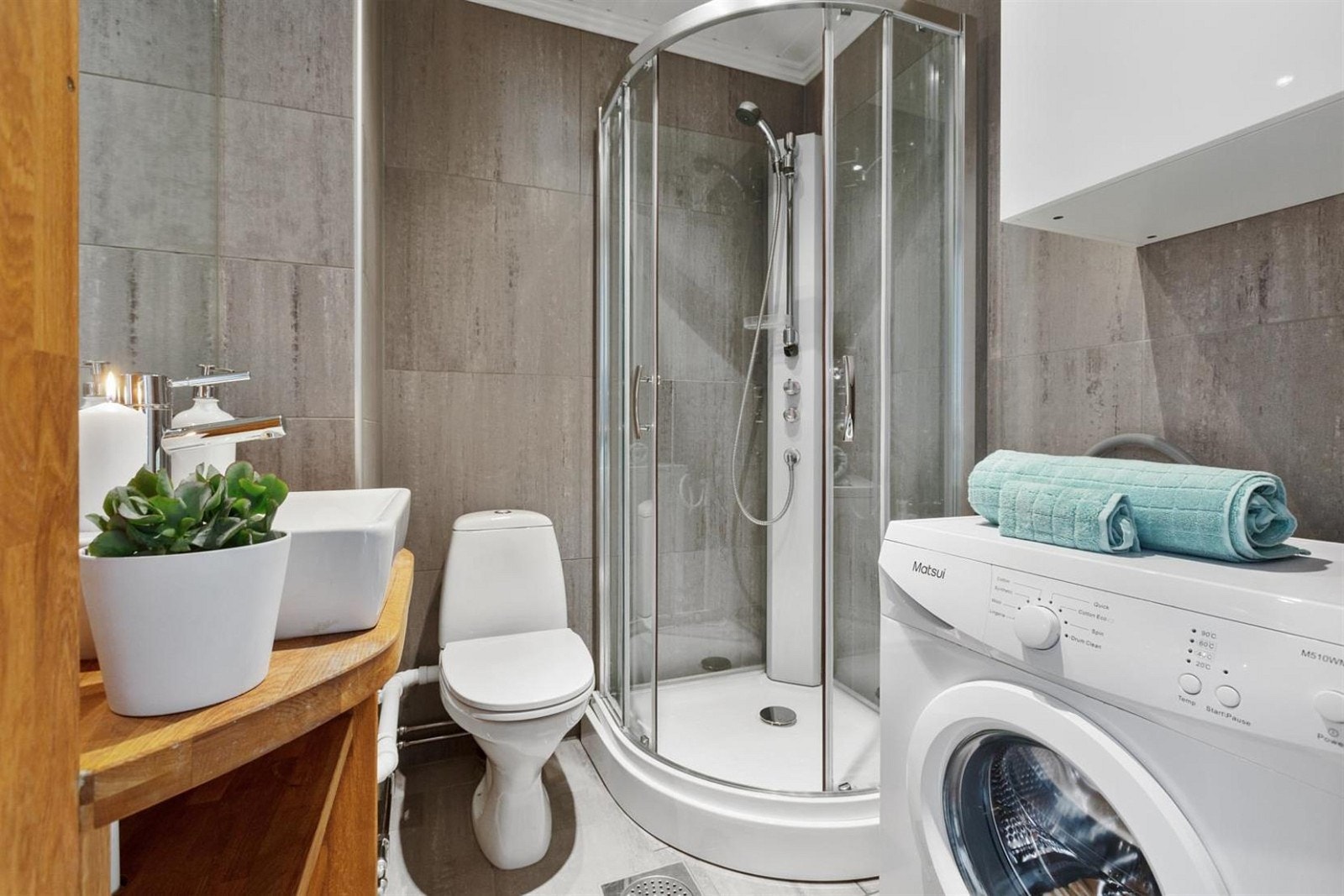 Bad med dusjkabinett og opplegg til vaskemaskin. Galleribilde