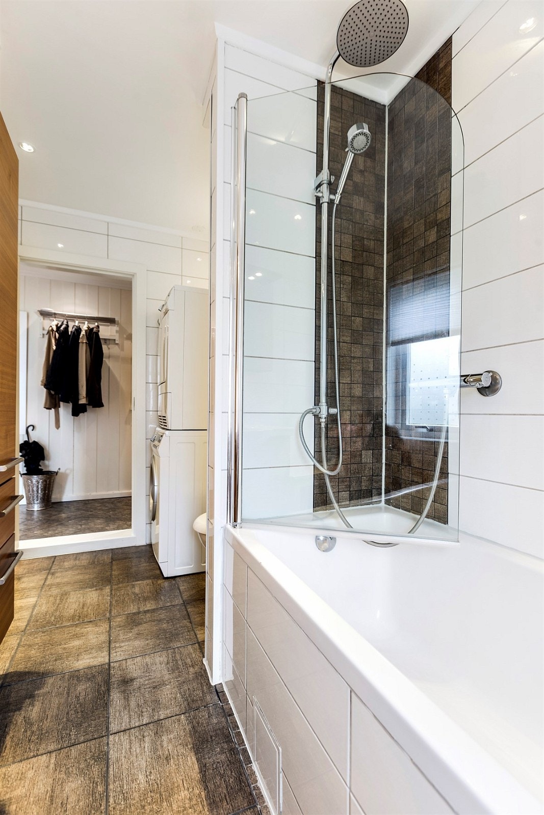 I tillegg finnes det veggmontert toalett, innebygget badekar med dusj samt opplegg for vaskemaskin og tørketrommel Galleribilde