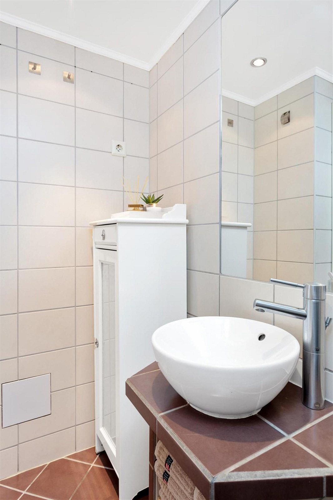 Badet er flott og lyst, med god belysning fra downlights i tak. Bak skapet er det opplegg for vaskemaskin. Galleribilde