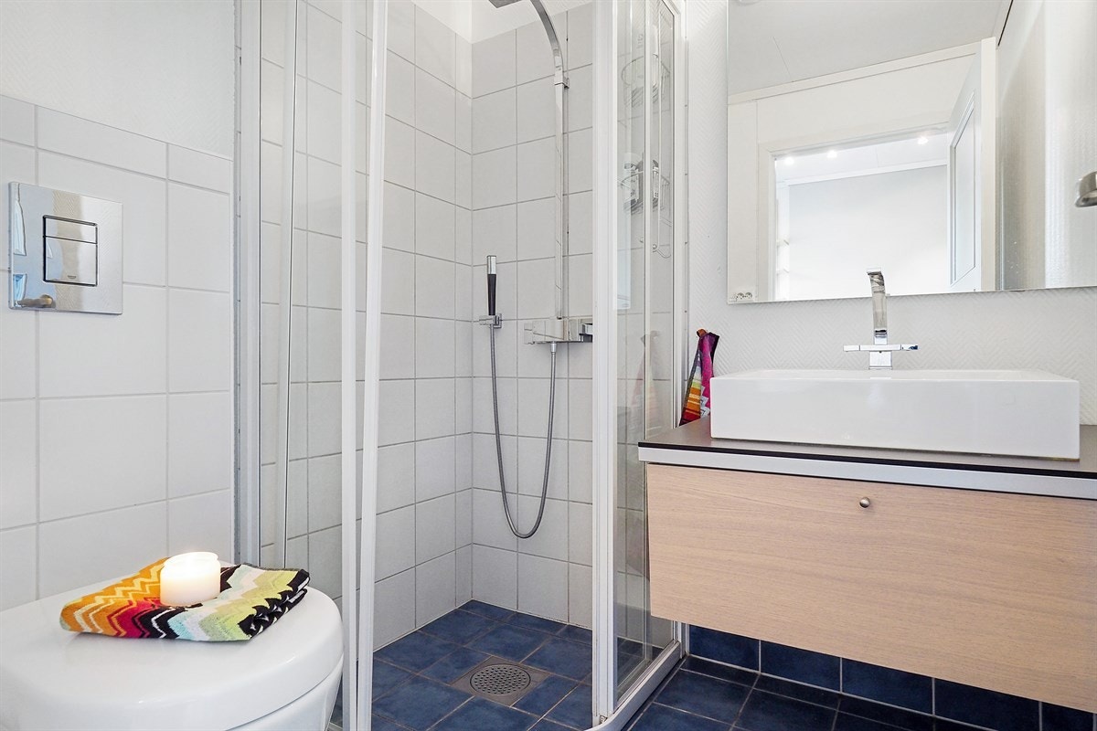 Bad i første etasje med HTH innredning, dusj og varmekabler i gulv. Galleribilde