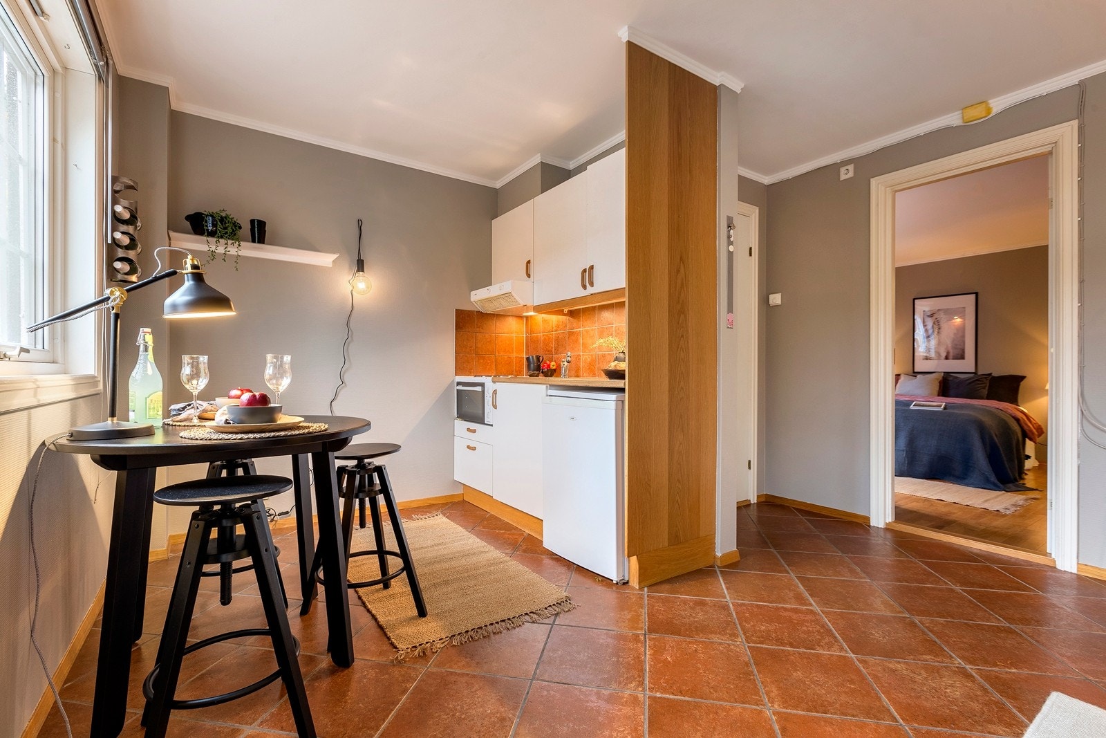 Stue mot kjøkken i utleie- leilighten kveldstid. Galleribilde