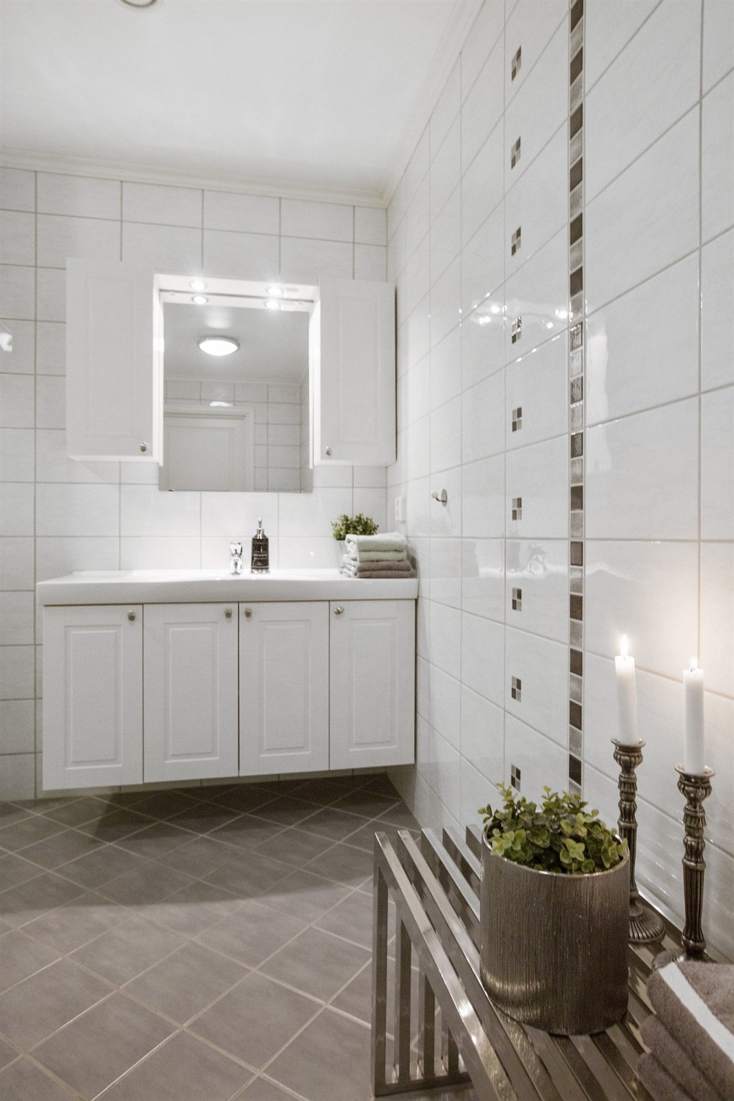 Stort bad med vegghengt wc og innredning i hvit profil Galleribilde