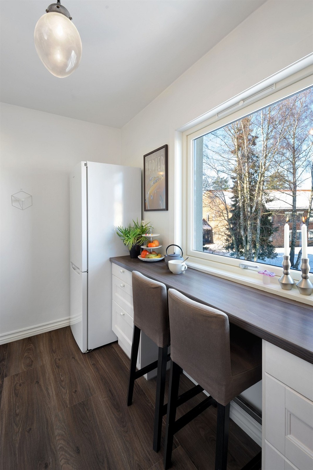 Hyggelig spiseplass/arbeidsplass på kjøkkenet ved vinduet Galleribilde