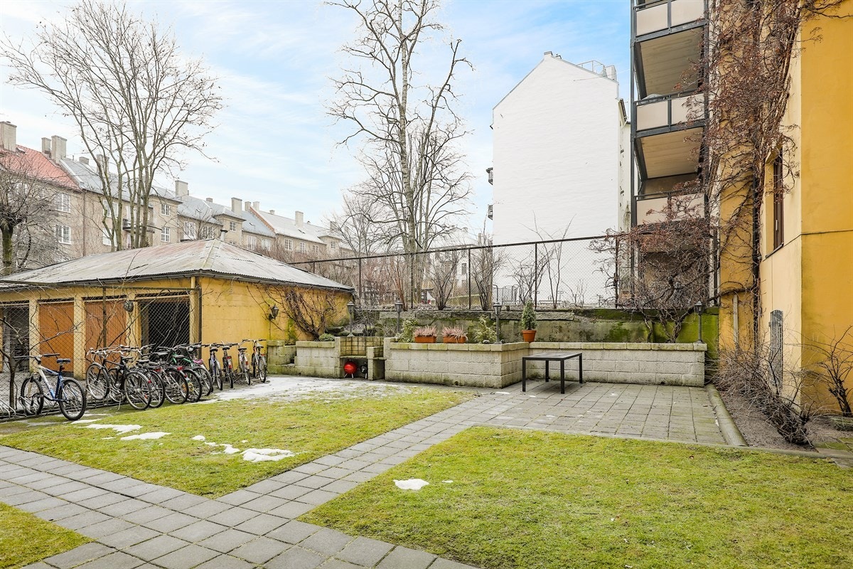 Pent opparbeidet lukket bakgård med sykkelparkering og sittegrupper Galleribilde