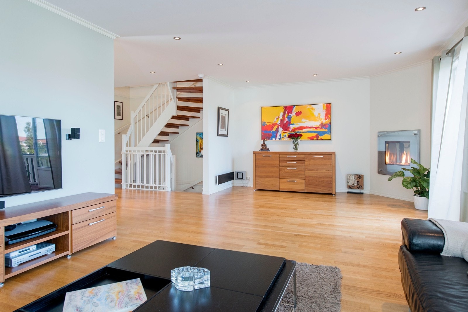 Stue med gasspeis og utgang til terrasse og hage Galleribilde