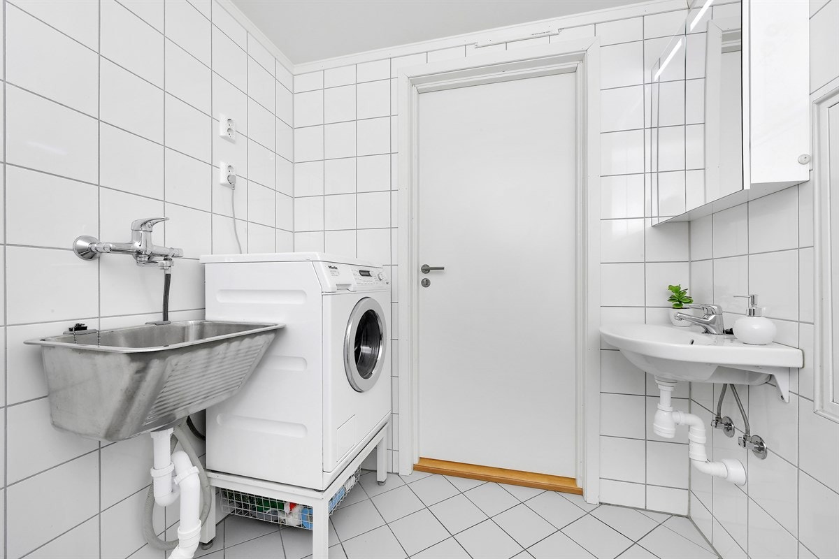 Vaskerommet/Bad 2 har grå gulvfliser, hvite veggfliser og gulvvarme. Galleribilde
