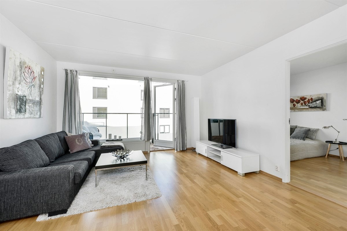 Stuen har parkett på gulv og veggene er holdt i nøytralt lyst, noe som gjør det enkelt å tilpasse eget møblement i form av sofaløsning og spisebord. Galleribilde