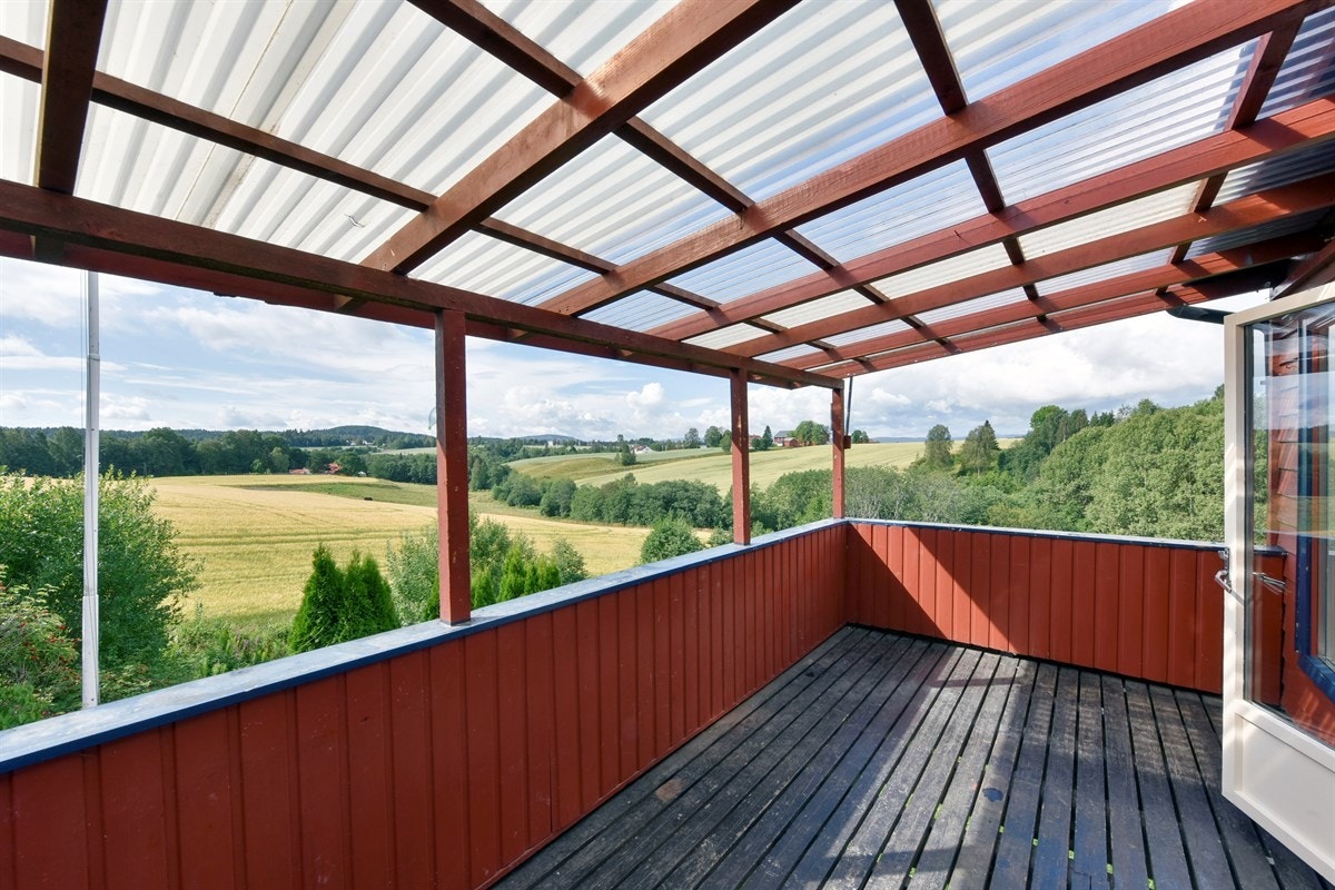Ut mot hagen er det laget en overbygd terrasse og på gårdsplassen finnes en enkel garasje. Galleribilde