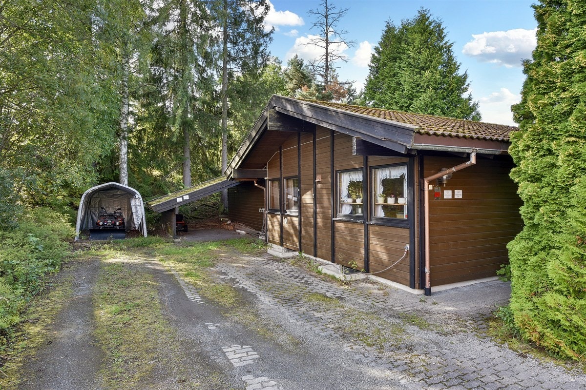 Det er parkering i en eldre carport og plass for parkering av flere biler på egen eiendom. Det er også satt opp en plastgarasje for oppbevaring av redskaper. Galleribilde