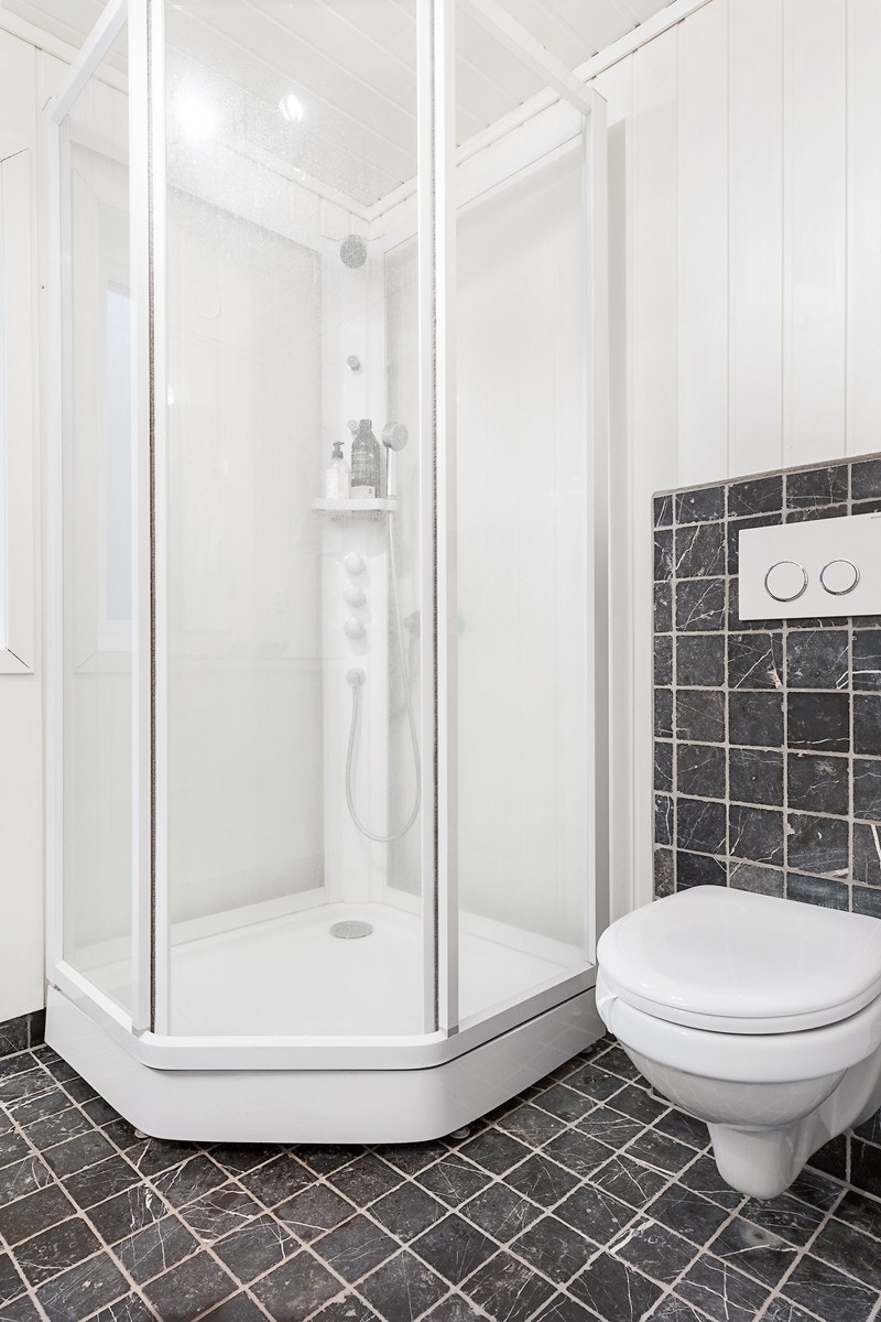 Badet har opplegg for vaskemaskin og praktisk dusjkabinett Galleribilde