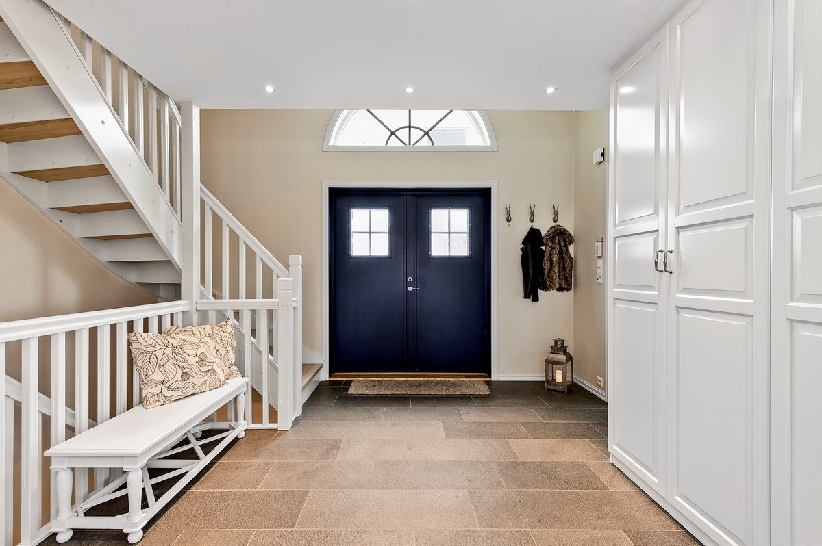 Boligen har et herskapelig inngangsparti med støpt trapp, søyler og tofløyet ytterdør. Galleribilde