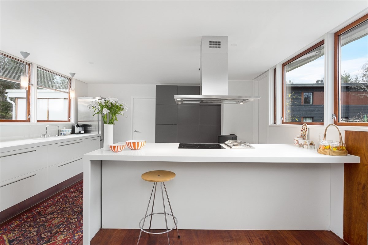 En praktisk barløsning med sitteplasser skaper et naturlig skille mellom stue og kjøkken. Galleribilde