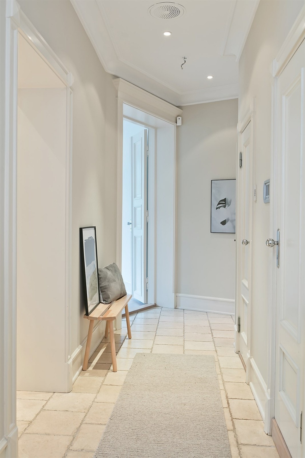 Entréen med downlights og gulv belagt med fliser over varmekabler Galleribilde