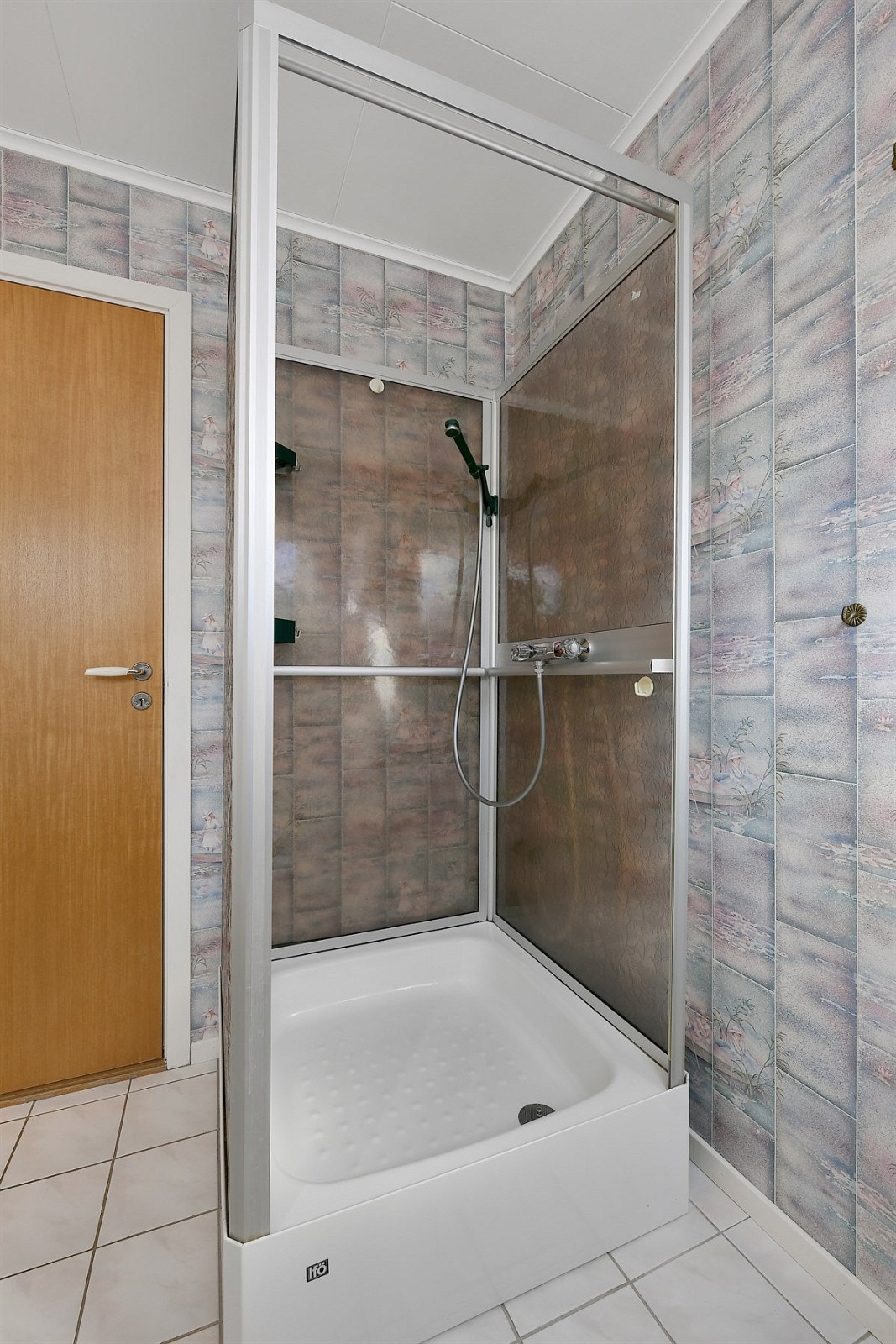 Det ene badet ligger i første etasje og har flissatte overflater med varme i gulv, samt et høytsittende vindu. Galleribilde