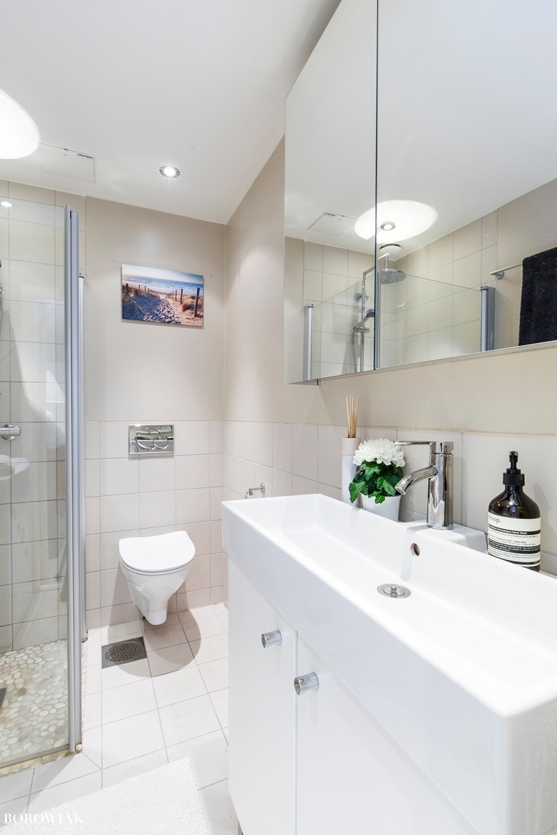 Varmekabler i gulv og downlights belysning i tak. Badet har et dusjhjørne med glassvegger og regnfallsdusj. Galleribilde