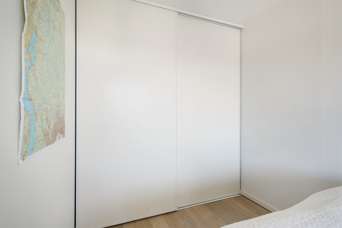 Stor skyvedørsgarderobe på soverom. Galleribilde