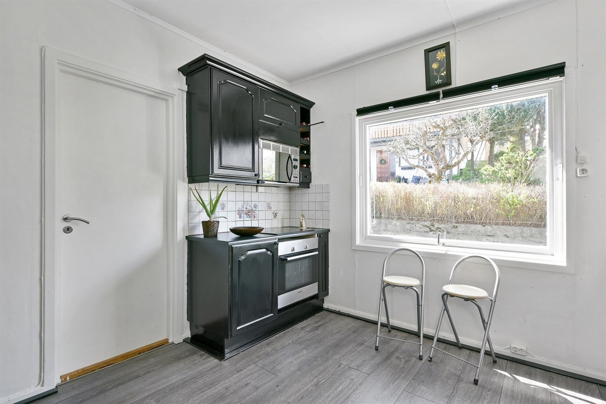 Videre inneholder kjøkkenet stekeovn, koketopp, ventilator, mikrobølgeovn, opplegg for oppvaskmaskin, samt nisje til kjøleskap. Galleribilde