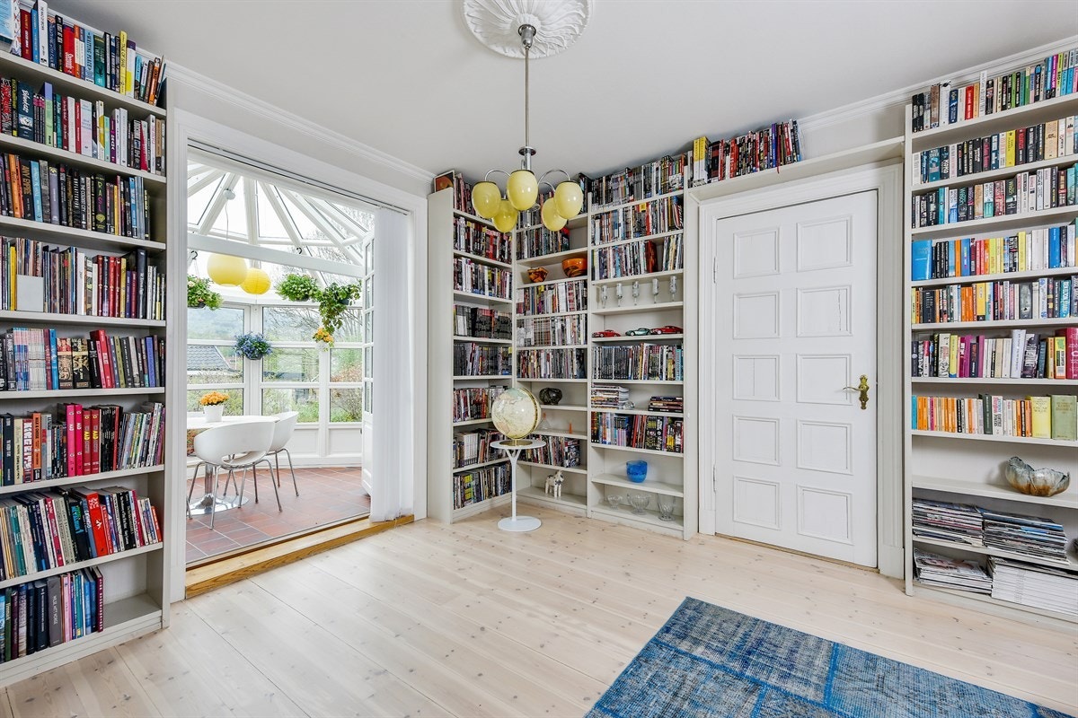 Biblioteket har tofløyede dører til vinterhagen hvor glassflatene slipper dagslyset inn fra syd og vest. Galleribilde