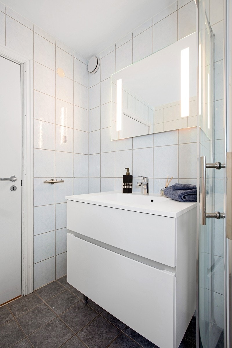 Moderne servant nedfelt i skuffeinnredning samt speil med innfelt belysning Galleribilde