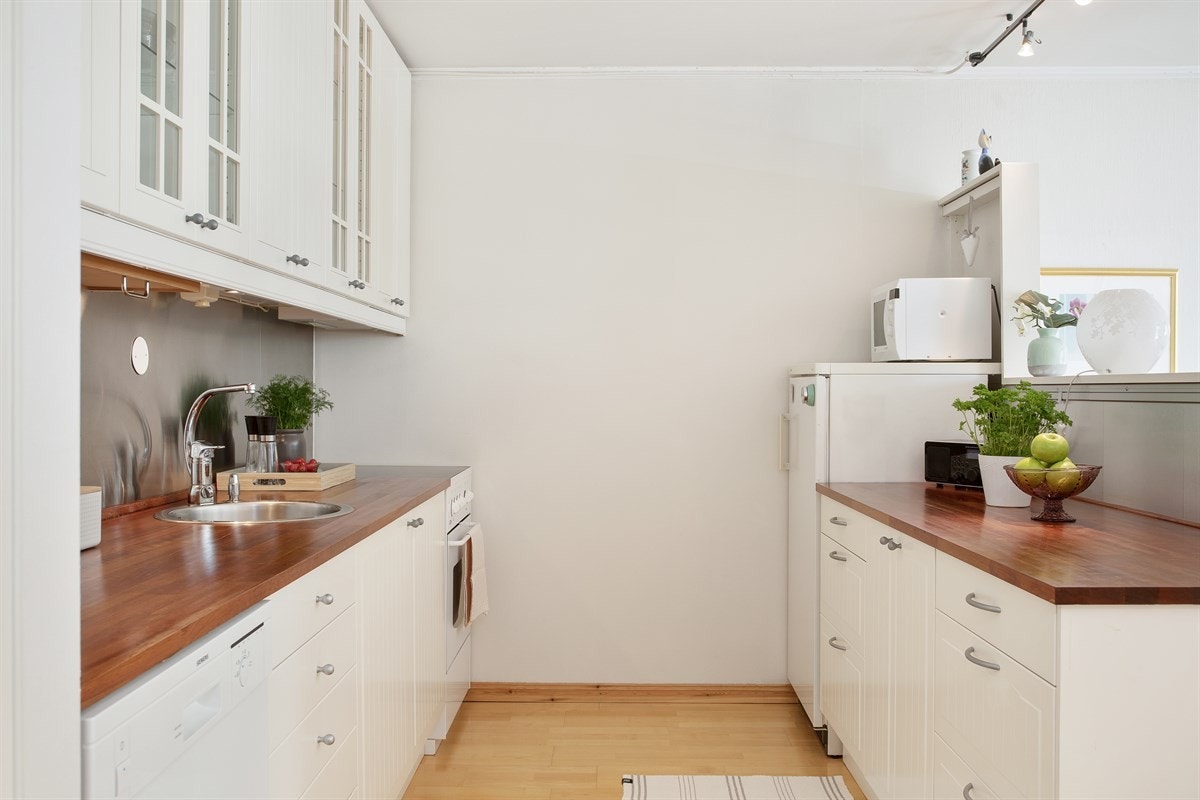 Kjøkkeninnredning med glatte hvite fronter Galleribilde