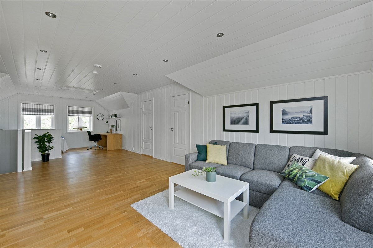 Loftstuen er av god størrelse, noe som gir plass for både sofa, tv-møbel og kontorløsning. Galleribilde