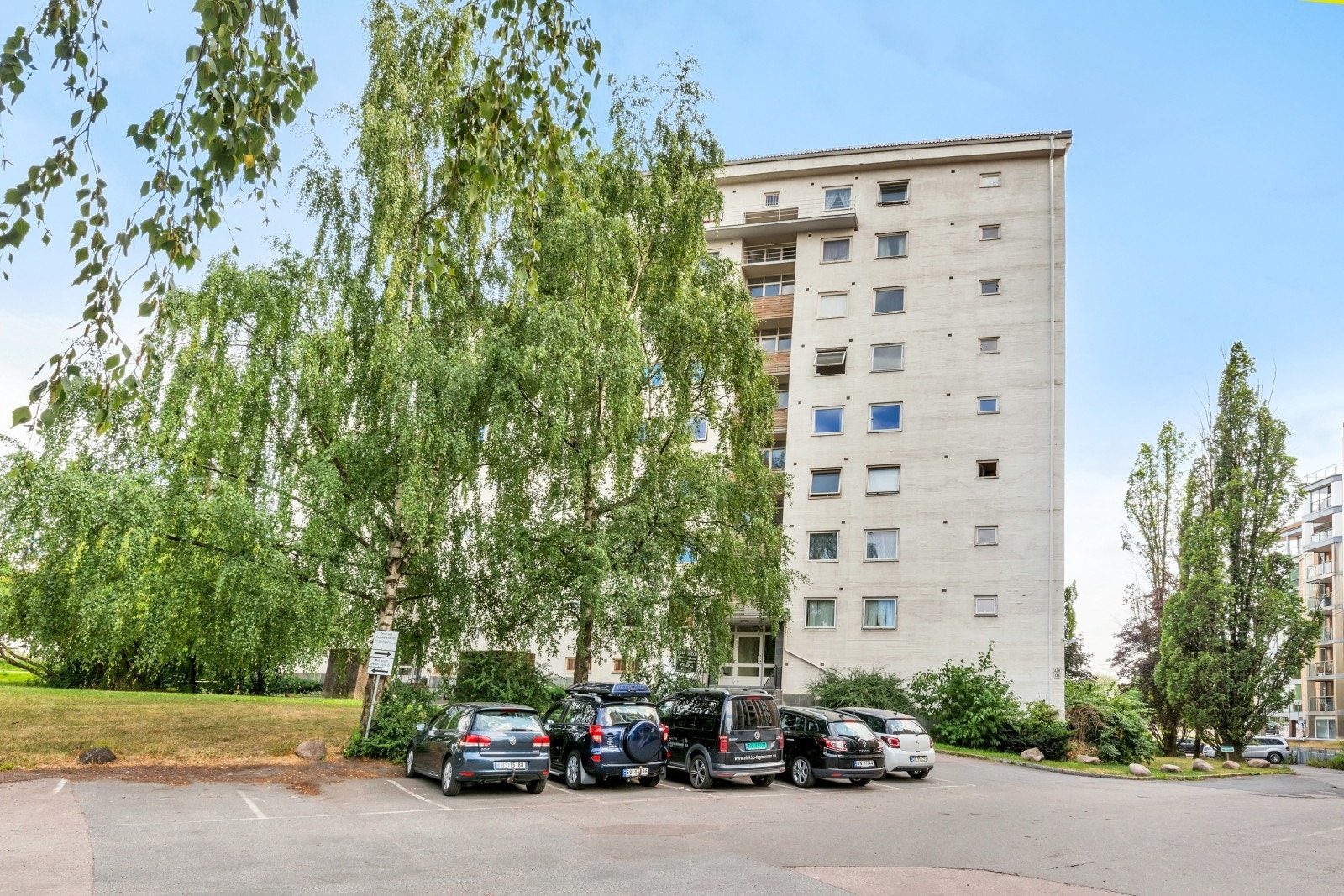 Store grønne fellesområdet og parkering rett utenfor blokken. Galleribilde