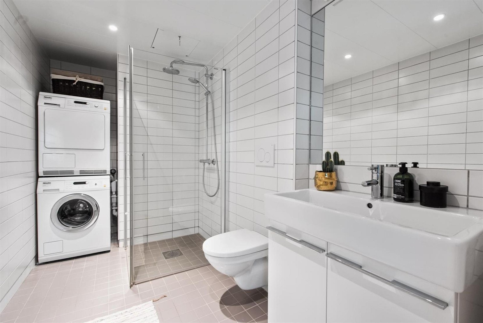 Delikat flislagt bad i 1. etg. med dusjsone med innfellbare glassvegger, samt servant med underskap og speil over. Opplegg til vask/tørk, samt vegghengt toalett. Galleribilde