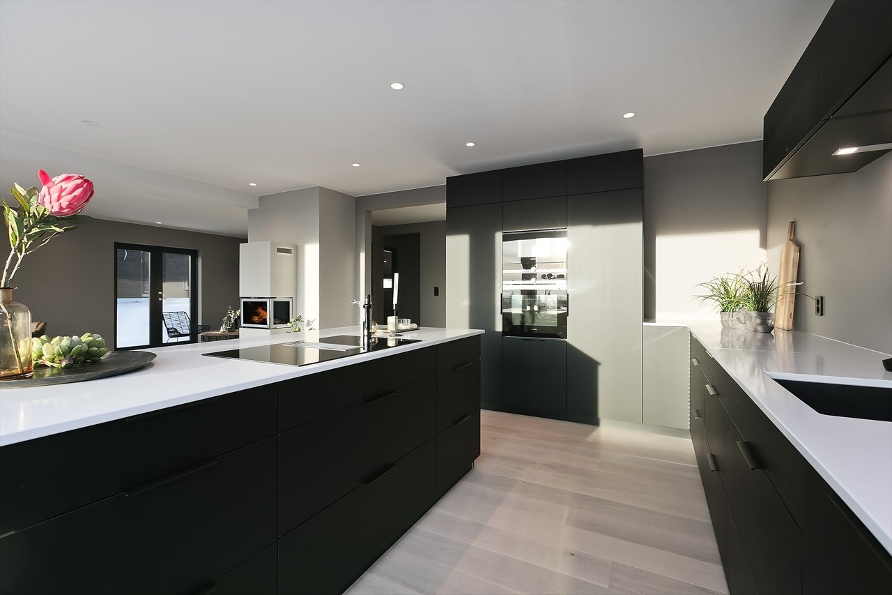 Påkostet kjøkkeninnredning fra KVIK, med fronter i matt utførelse og benkeplate i stein Galleribilde